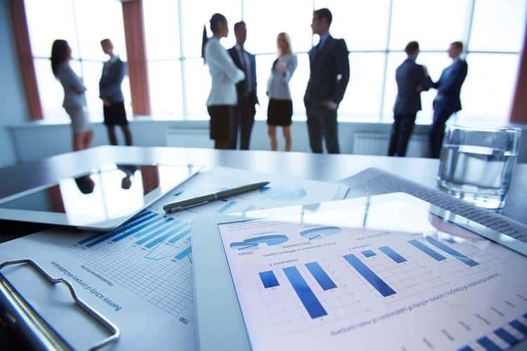 Graphs and charts with business professionals networking and talking